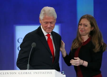 Former U.S. President Bill Clinton takes the stage as his daughter Chelsea Clinton embraces during the closing session of the Clinton Global Initiative 2016 (CGI) in New York, U.S., September 21, 2016. REUTERS/Shannon Stapleton