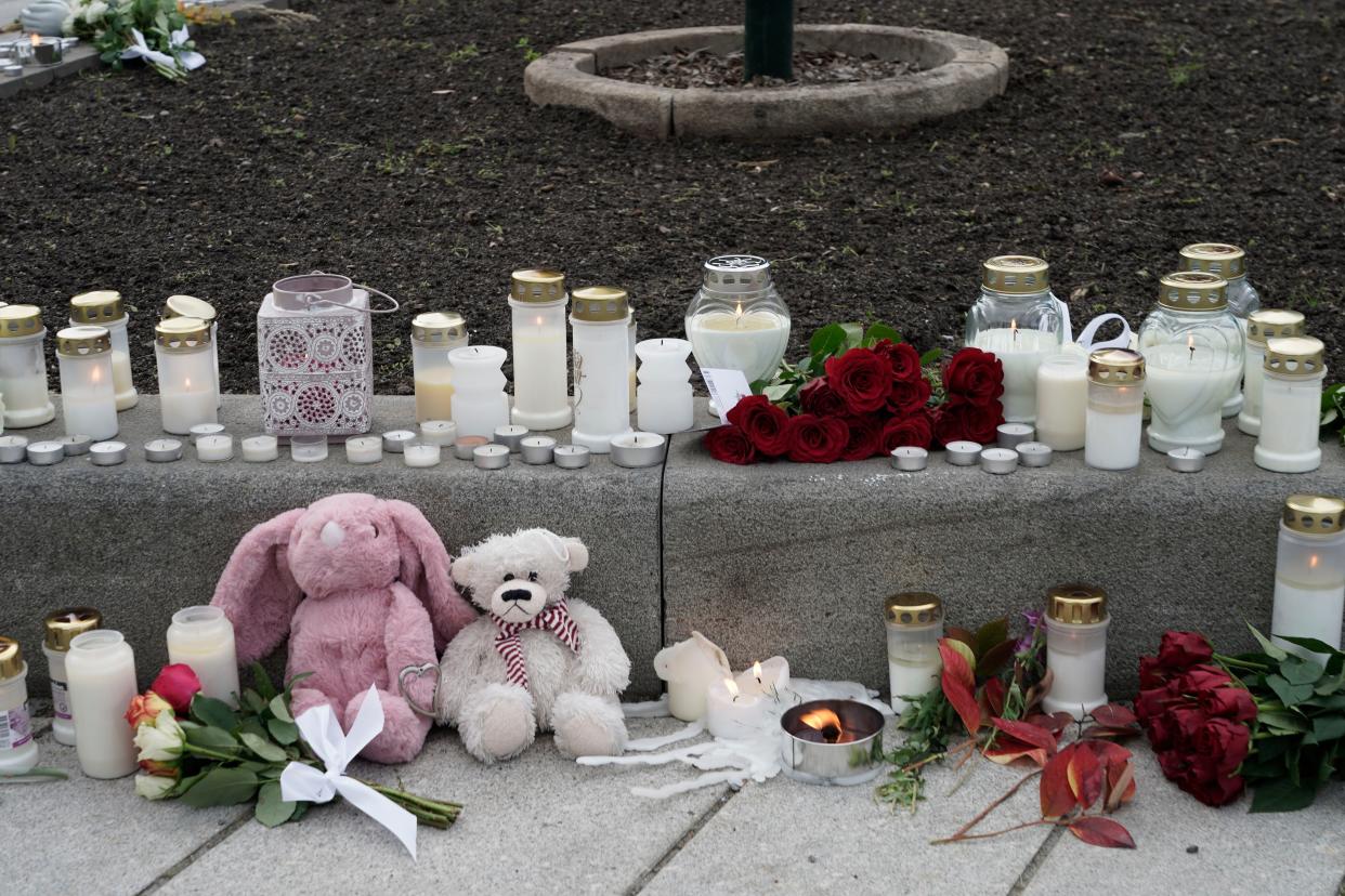 Flowers and candles were left after a man killed several people, in Kongsberg, Norway, Thursday, Oct. 14, 2021. 