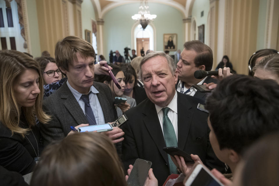 Sen. Dick Durbin, D-Ill., the assistant Democratic leader, is surrounded by reporters asking about the possibility of a partial government shutdown, at the Capitol in Washington, Tuesday, Dec. 18, 2018. Congress and President Donald Trump continue to bicker over his demand that lawmakers fund a wall along the U.S.-Mexico border, pushing the government to the brink of a partial shutdown at midnight Friday. (AP Photo/J. Scott Applewhite)