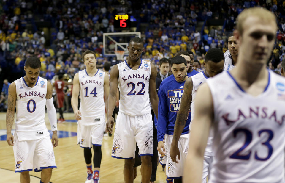 Kansas players walk off the court following their loss in a third-round game against Stanford at the NCAA college basketball tournament Sunday, March 23, 2014, in St. Louis. Stanford won the game 60-57. (AP Photo/Charlie Riedel)