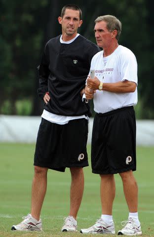 <p>Tracy A Woodward/The Washington Post/Getty </p> Kyle Shanahan and his father Mike Shanahan at the afternoon Training Camp in Ashburn, VA on August 18, 2010.