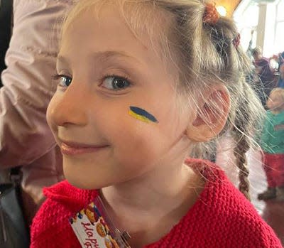 At a Ukrainian family festival held by Jacksonville-based missionary Kathy Gould's nonprofit, face painting was available and this girl was one of many children who chose to have the colors of the nation's flag painted on her face.