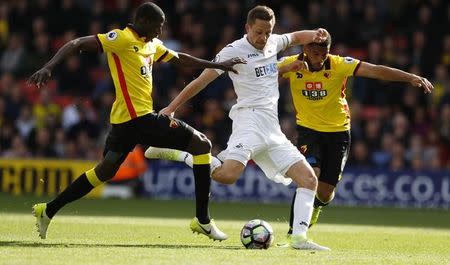 Britain Soccer Football - Watford v Swansea City - Premier League - Vicarage Road - 15/4/17 Swansea City's Gylfi Sigurdsson in action with Watford's Adrian Mariappa Reuters / Peter Nicholls Livepic