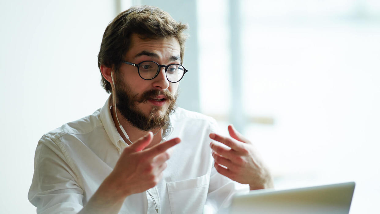 Young specialist communicating with employer through video-chat.