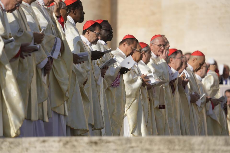 Cardinals attend a mass presided over by Pope Francis and concelebrated by the new cardinals for the start of the XVI General Assembly of the Synod of Bishops in St. Peter's Square at The Vatican, Wednesday, Oct.4, 2023. Pope Francis is convening a global gathering of bishops and laypeople to discuss the future of the Catholic Church, including some hot-button issues that have previously been considered off the table for discussion. Key agenda items include women's role in the church, welcoming LGBTQ+ Catholics, and how bishops exercise authority. For the first time, women and laypeople can vote on specific proposals alongside bishops (AP Photo/Andrew Medichini)