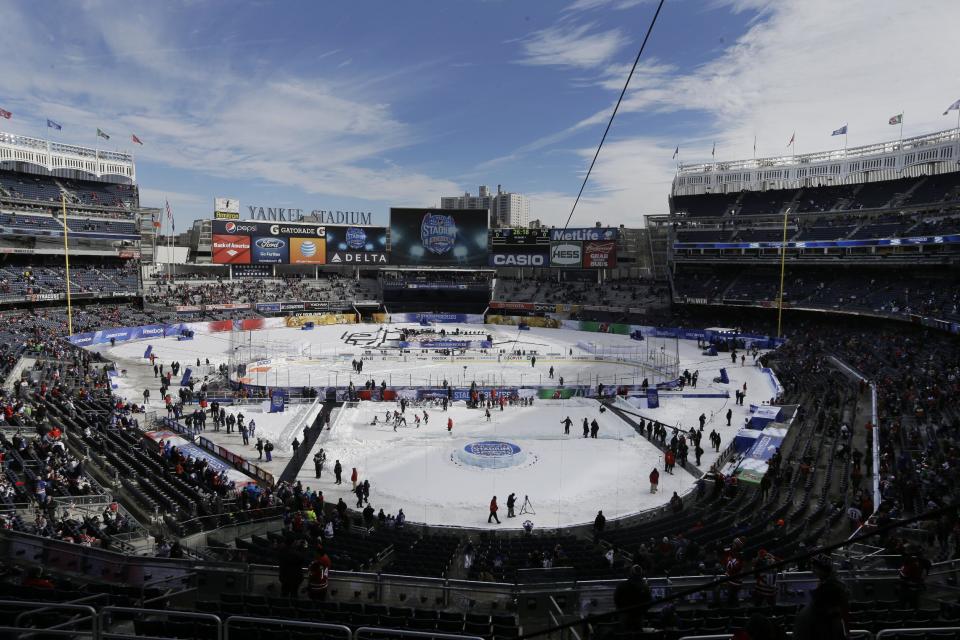 Fans wait for the start of an outdoor NHL hockey game between the New Jersey Devils and the New York Rangers Sunday, Jan. 26, 2014, at Yankee Stadium in New York. (AP Photo/Frank Franklin II)