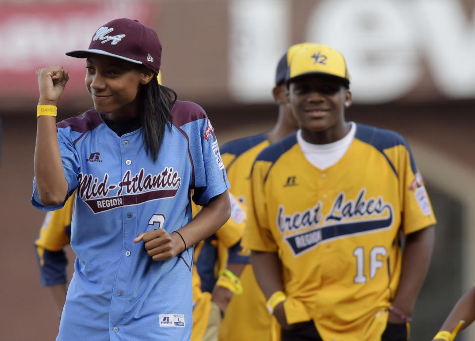 Oct 25, 2014; San Francisco, CA, USA; Little League baseball player Mo'ne Davis reacts after throwing out a ceremonial first pitch before game four of the 2014 World Series between the San Francisco Giants and the Kansas City Royals at AT&T Park. Mandatory Credit: Christopher Hanewinckel-USA TODAY Sports