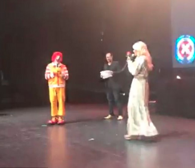 Sophie Monk posted a snap of herself giving a rose to Ronald McDonald onstage at the charity event. Source: Instagram