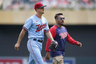 Minnesota Twins starting pitcher Tyler Mahle, left, exits the game with head athletic trainer Michael Salazar during the third inning of a baseball game against the Kansas City Royals Wednesday, Aug. 17, 2022, in Minneapolis. (AP Photo/Abbie Parr)