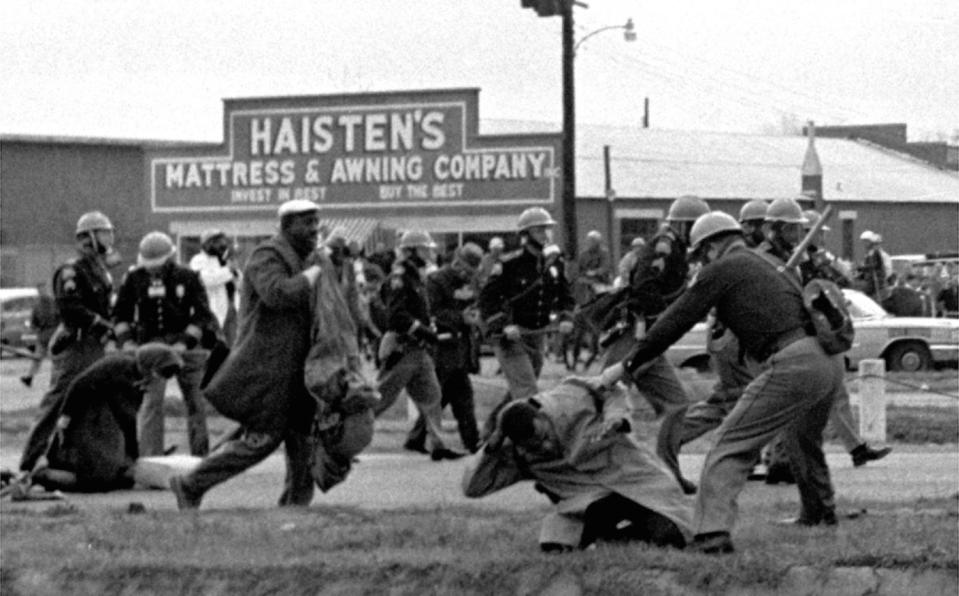 At foreground right, John Lewis, is beaten by a state trooper.
