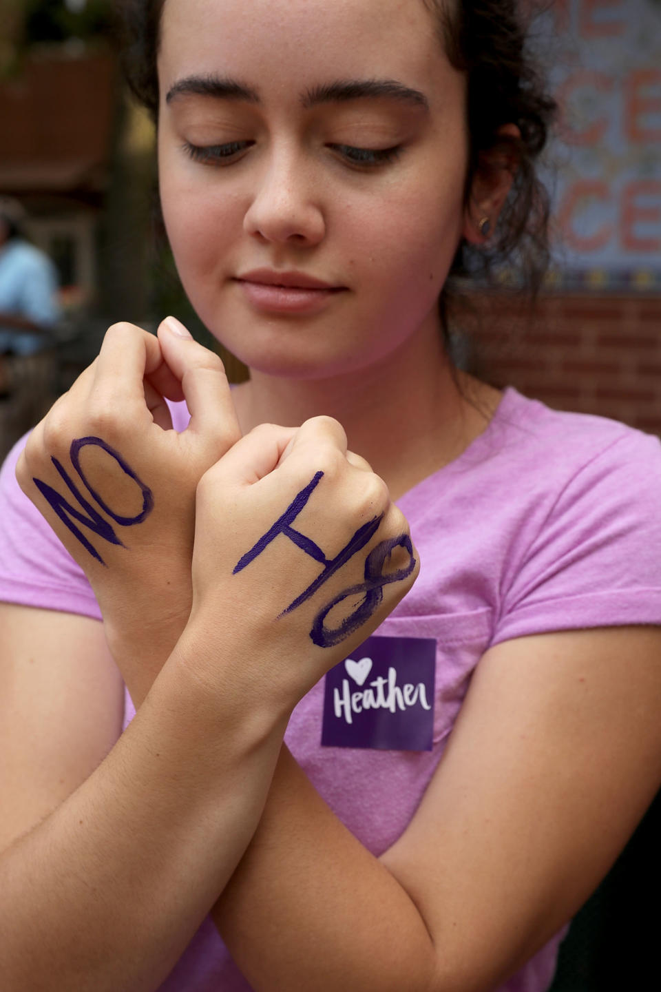 Mia Jones shows off the "NO H8" message written on her hands.