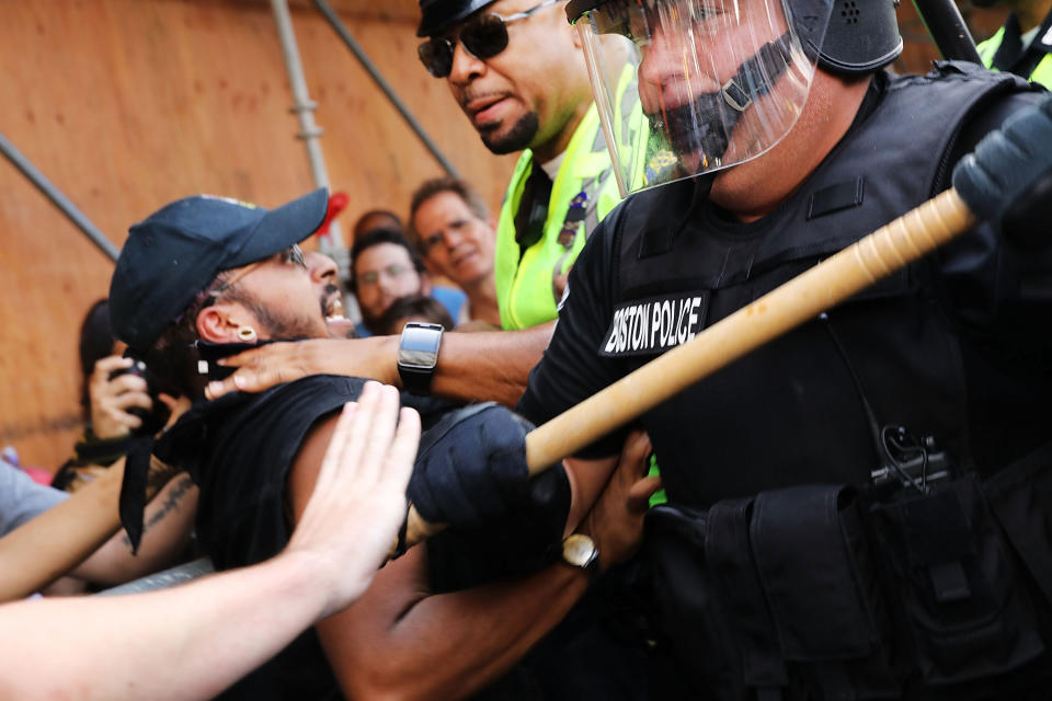 <p>A counter-protester clashes with police.</p>