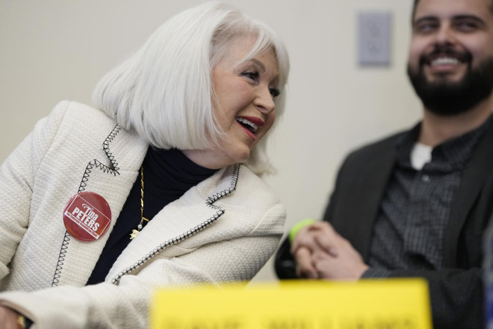 Candidate for the Colorado Republican Party chair position Tina Peters, left, jokes with fellow candidate Dave Williams during a debate sponsored by the Republican Women of Weld, Saturday, Feb. 25, 2023, at a pizza restaurant in Hudson, Colo. (AP Photo/David Zalubowski)