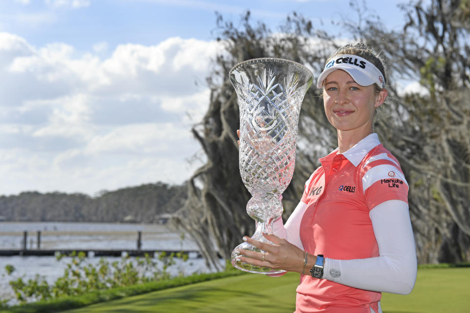 Nelly Korda celebrates with the winner's trophy after the final round of the Gainbridge LPGA golf tournament Sunday, Feb. 28, 2021, in Orlando, Fla. (AP Photo/Stan Badz)