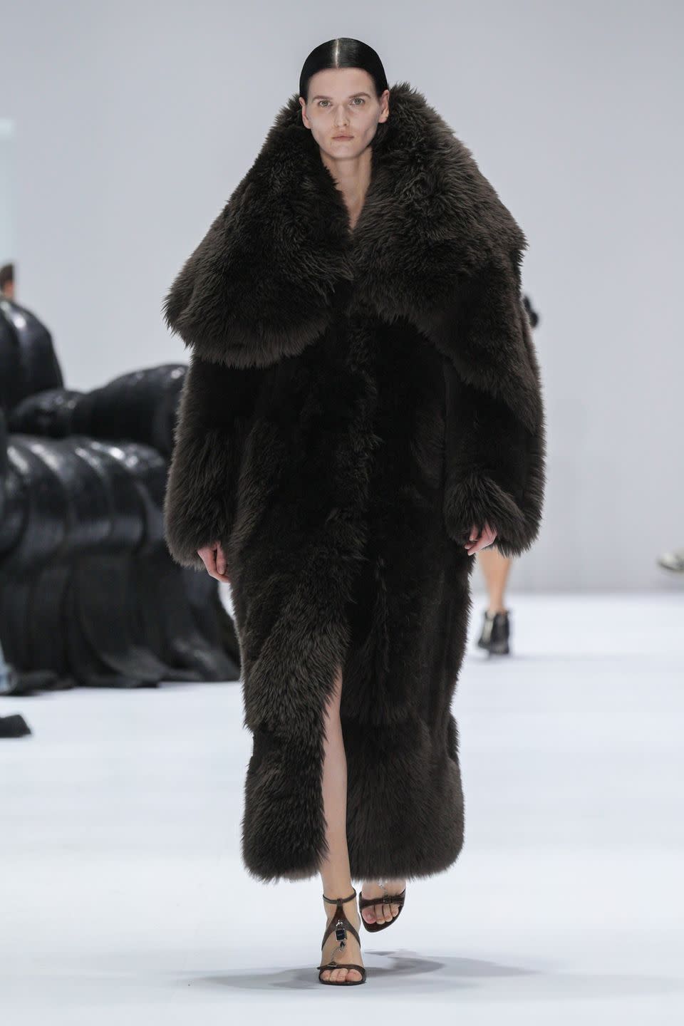 a person wearing a black fur coat