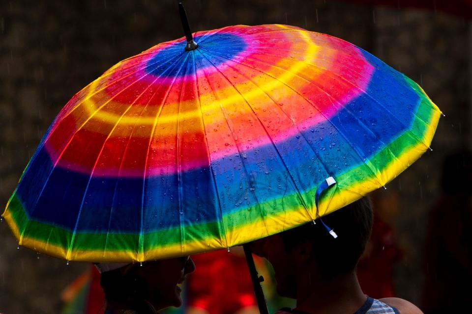 In this file photo, rain falls during the 4th Annual Naples Pride Fest, Saturday, July 9, 2022, at Cambier Park in Naples, Fla. The festival was postponed from June to July because of inclement weather.