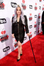 <p>Despite accessorizing with a cane (injury unknown), Kelly Osbourne still paired high heels with her black minidress. <i><i>(Photo: Getty Images)</i></i></p>