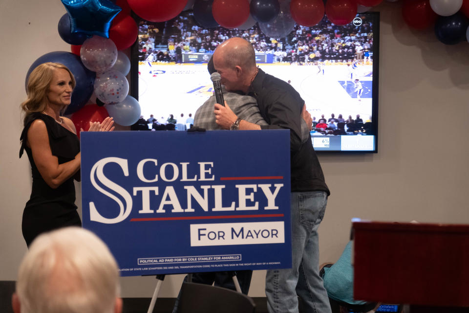 Newly elected mayor Cole Stanely receives a hug from businessman Alex Fairly after winning the mayor's race Saturday at Hodgetown in downtown Amarillo.