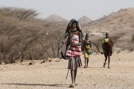 A Turkana girl walks away from a waterhole near Lodwar, in Turkana County, Kenya February 7, 2018. REUTERS/Baz Ratner