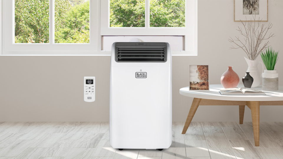 the portable air conditioner installed near a window in a living room