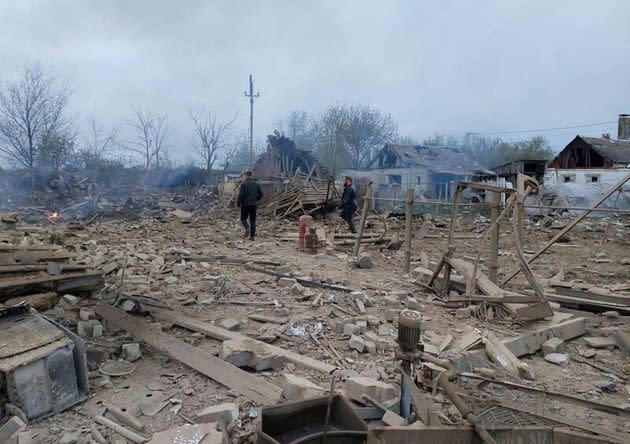 People are seen at the site of a residential area hit by a Russian military strike, amid Russia's attack on Ukraine, in the town of Pavlohrad, Dnipropetrovsk region.