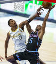 Dallas Mavericks guard Josh Richardson (0) fouls Sacramento Kings guard De'Aaron Fox (5) during the second half of a NBA basketball game, Sunday, April 18, 2021, in Dallas. (AP Photo/Brandon Wade)