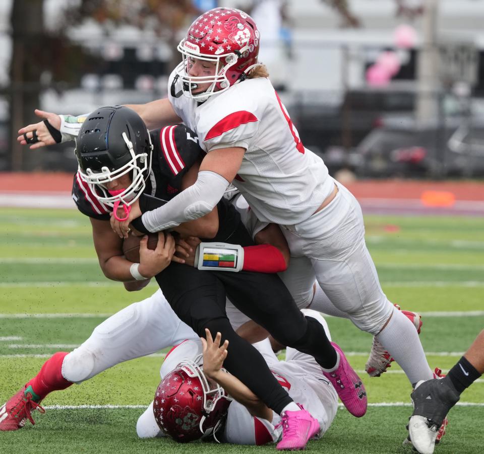 East Rutherford, NJ — October 28, 2023 -- Kyle Shamah of Elmwood Park tackles Manny De La Hoz of Weehawken in the second half. Weehawken defeated Elmwood Park 28-19 to win the NJIC Union Division championship played in East Rutherford.