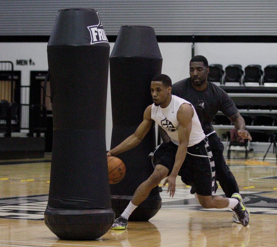 Providence's Bryce Cotton, left, works out with God Shammgod at Alumni Hall at PC in 2014.