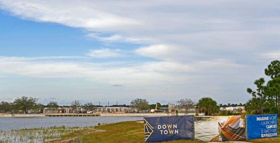 This image from November, 2021 shows a view of the 80-acre man-made lake in Wellen Park from Preto Boulevard, along with a banner sign touting the future of Downtown Wellen.