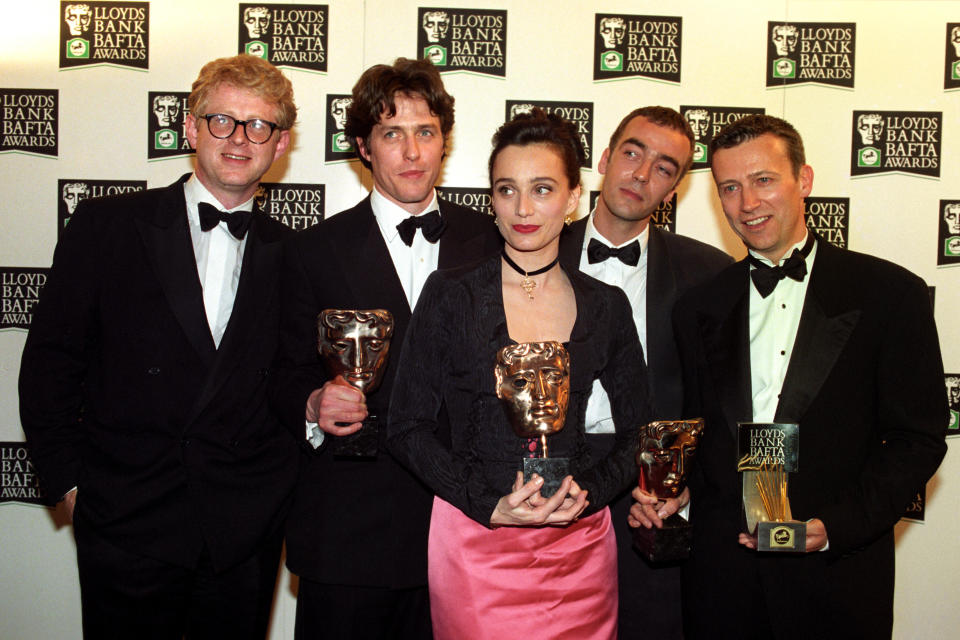 BAFTA AWARDS CEREMONY AT THE LONDON PALLADIUM. HUGH GRANT WHOSE MOVIE FOUR WEDDINGS AND A FUNERAL SCOOPED THE BOARD WITH FIVE AWARDS. IN LINE UP- (L-R) RICHARD CURTIS, HUGH GRANT, KRISTIN SCOT-THOMAS, JOHN HANNAH AND DUNCAN KENWORTHY.   (Photo by Sean Dempsey - PA Images/PA Images via Getty Images)