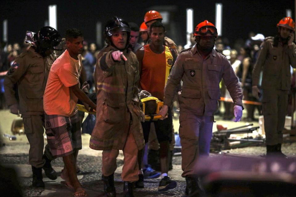 Rio crash: Emergency services help an injured pedestrian at the scene (EPA)