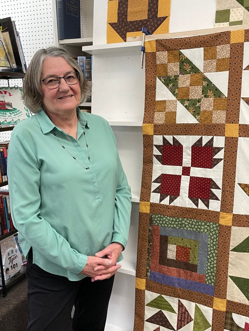 Regina Feldpausch of Petersburg talked about quilts at the Book Nook Saturday. Feldpausch made this quilt, which shows some of the patterns made by enslaved people that may have given others information about the Underground Railroad. The block second from the top is called bear paw and is one of Feldpausch's favorite from the era.