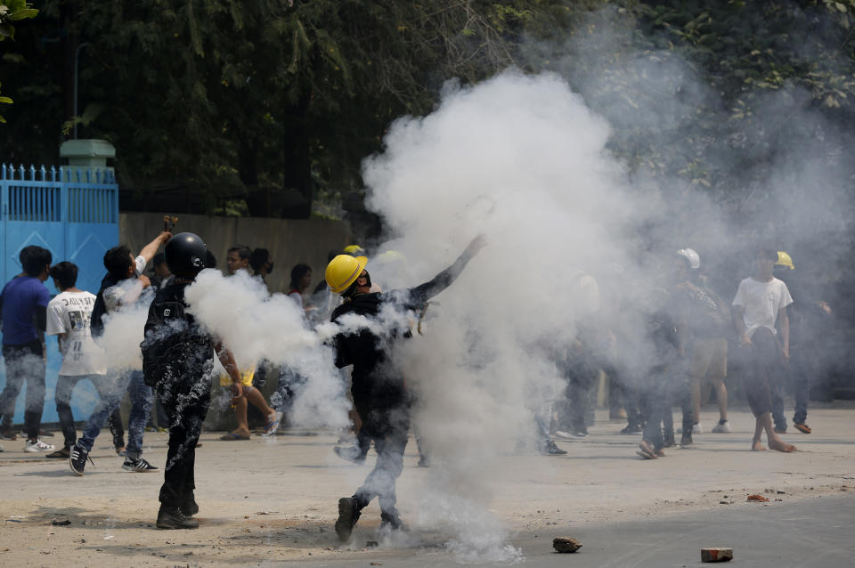 Demonstrators hurl back tear gas canisters towards police during a protest against the military coup Saturday, March 27, 2021, in Mandalay, Myanmar. Myanmar security forces reportedly killed 93 people Saturday in the deadliest day since last month’s military coup. (AP Photo)