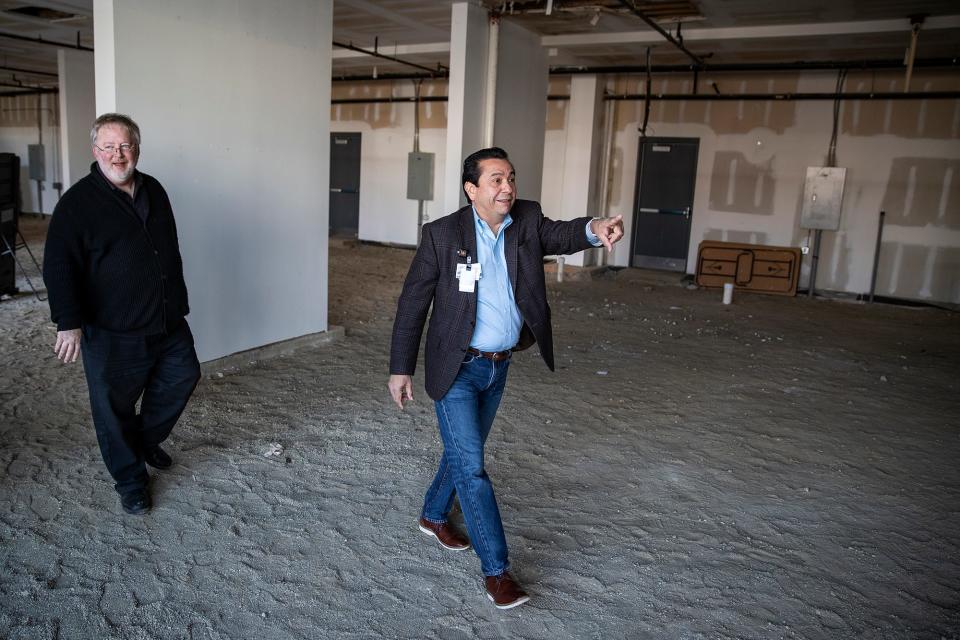From left, Jim Strietelmeier and Dr. Javier Sevilla walk through the vacant space that later became the Compassion Clinic on the near east side of Indianapolis on Saturday, Nov. 16, 2019. Strietelmeier was a pastor at Neighborhood Fellowship Church and Sevilla is medical director for the health clinic.