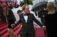 Alice Winocour, left, and John C. Reilly pose for photographers upon arrival at the premiere of the film 'Monster' at the 76th international film festival, Cannes, southern France, Wednesday, May 17, 2023. (AP Photo/Daniel Cole)