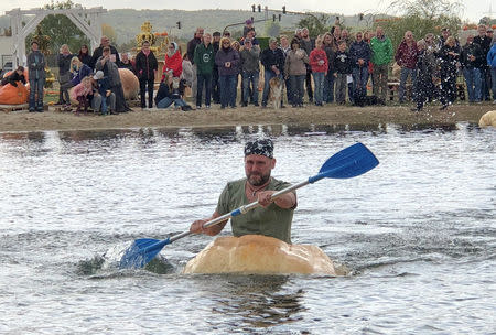 A man paddles his giant pumpkin boat during the raditional pumpkin race in Lohmar, Germany October 3, 2018. Reuters/David Sahl