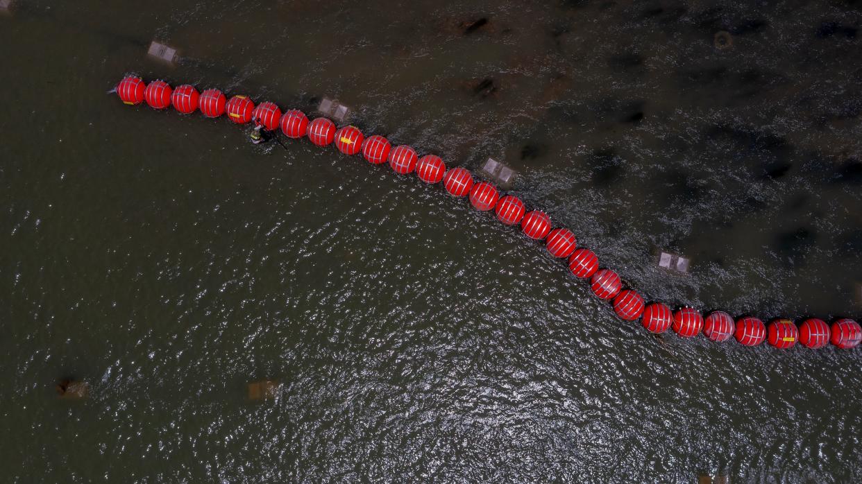 Buoys float on the Rio Grande River in Eagle Pass, Texas on Thursday.