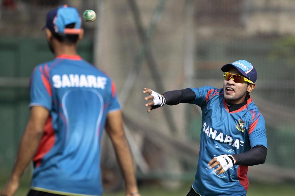 Bangladesh cricket team captain Mushfiqur Rahim right, throws a ball during a practice session ahead of the Asia Cup tournament in Dhaka, Bangladesh, Monday, Feb. 24, 2014. Pakistan plays Sri Lanka in the opening match of the five nation one day cricket event that begins Tuesday. (AP Photo/A.M. Ahad)