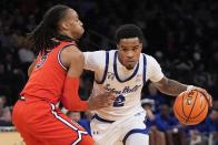 St. John's Daniss Jenkins (5) defends as Seton Hall's Al-Amir Dawes (2) drives during the first half of an NCAA college basketball game in the quarterfinal round of the Big East Conference tournament, Thursday, March 14, 2024, in New York. (AP Photo/Frank Franklin II)