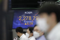 Currency traders watch computer monitors near the screens showing the Korea Composite Stock Price Index (KOSPI) at the foreign exchange dealing room in Seoul, South Korea, Monday, Sept. 28, 2020. Asian shares were mostly higher in muted trading Monday, ahead of the first U.S. presidential debate and a national holiday in China later in the week.(AP Photo/Lee Jin-man)