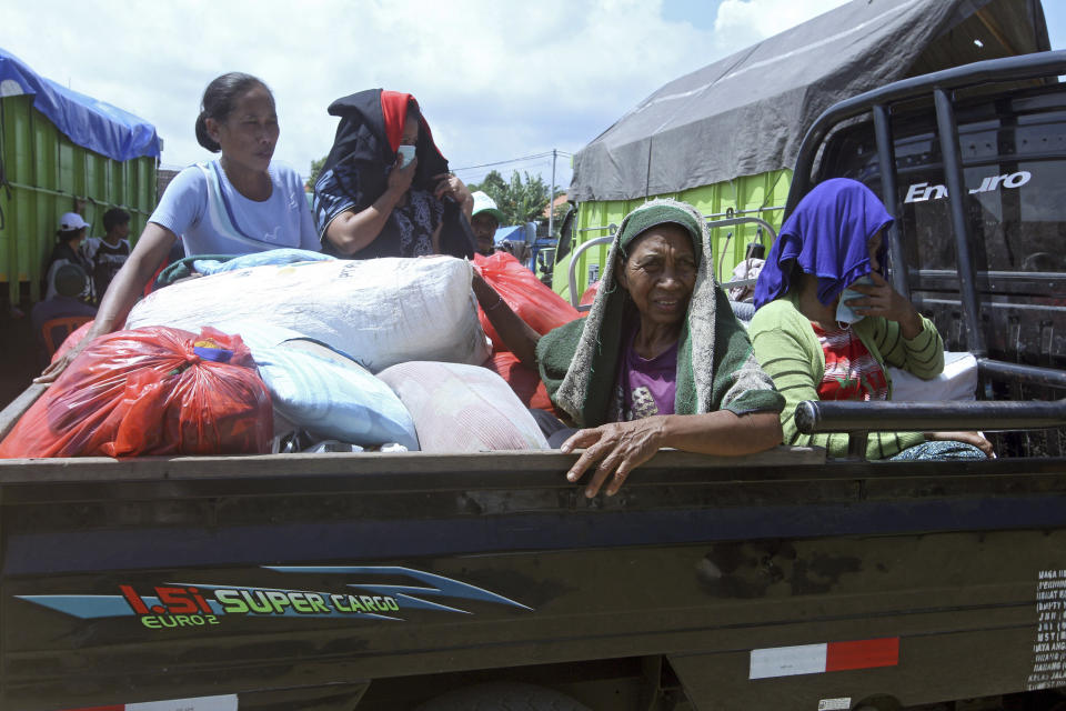 <p>Villagers who evacuated from their homes on the slope of Mount Agung sit in a truck upon arrival at a temporary shelter in Klungkung, Bali, Indonesia, Sept. 23, 2017. Thousands of villagers on the Indonesian resort island of Bali are sheltering in sports centers, village halls and with relatives, fearing Mount Agung will erupt for the first time in more than half a century. (AP Photo/Firdia Lisnawati) </p>