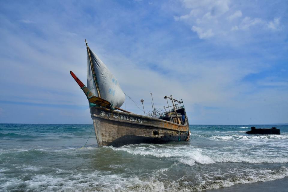 A boat used to carry ethnic Rohingya rests on Indra Patra beach in Indonesia’s Ladong village (AP)