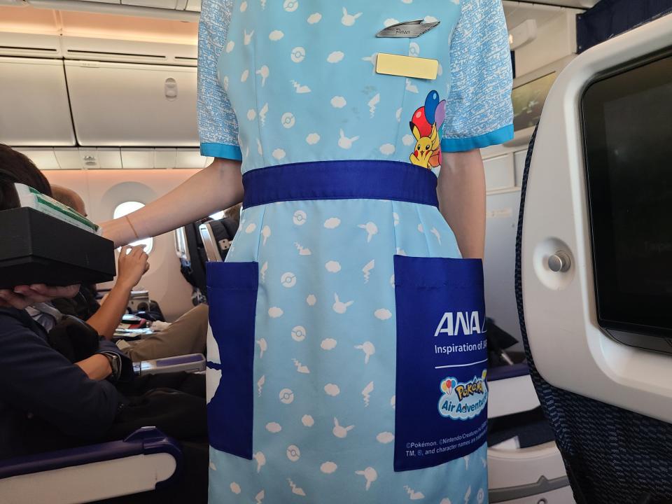 Pokemon-inspired apron on flight attendant