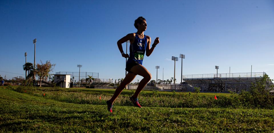 Sergi Guzman of Community School of Naples leads the Private 8 cross country running race at Bishop Verot on Saturday, Oct. 15, 2022. He would go on to win. 