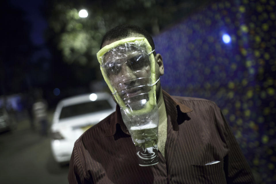 A supporter of Egypt's ousted President Mohammed Morsi poses with a home made gas mask during a protest near Cairo University in Giza, Egypt, Thursday, August, 1, 2013. (AP Photo/Manu Brabo)