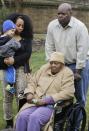 Bernice Youngblood, 85, center, a resident of the East Neck Nursing and Rehabilitation Center, listens during a news conference on the lawn of the nursing home with her granddaughter, Saniya Delgado and great-grandson Antonio, 2, left, and son, Darrell, right, Tuesday, April 8, 2014, in West Babylon, N.Y. The nursing home a hired male exotic dancer to perform for its patients, according to a lawsuit filed by Youngblood in State Supreme Court in Suffolk County. (AP Photo/Mark Lennihan)