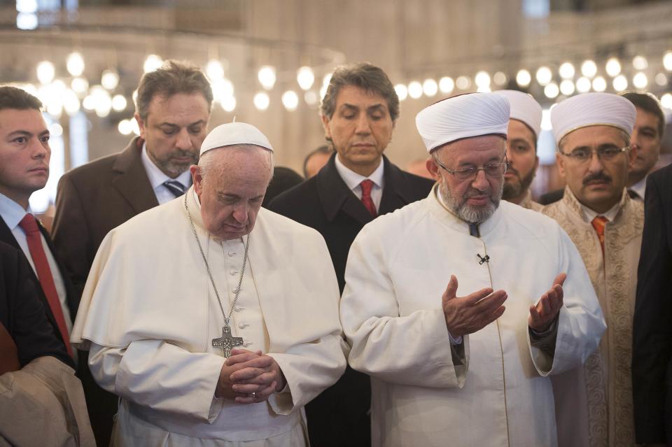 Pope Francis prays with Rahmi Yaran, Mufti of Istanbul during a visit to the Sultan Ahmet mosque, popularly known as the Blue Mosque, in Istanbul