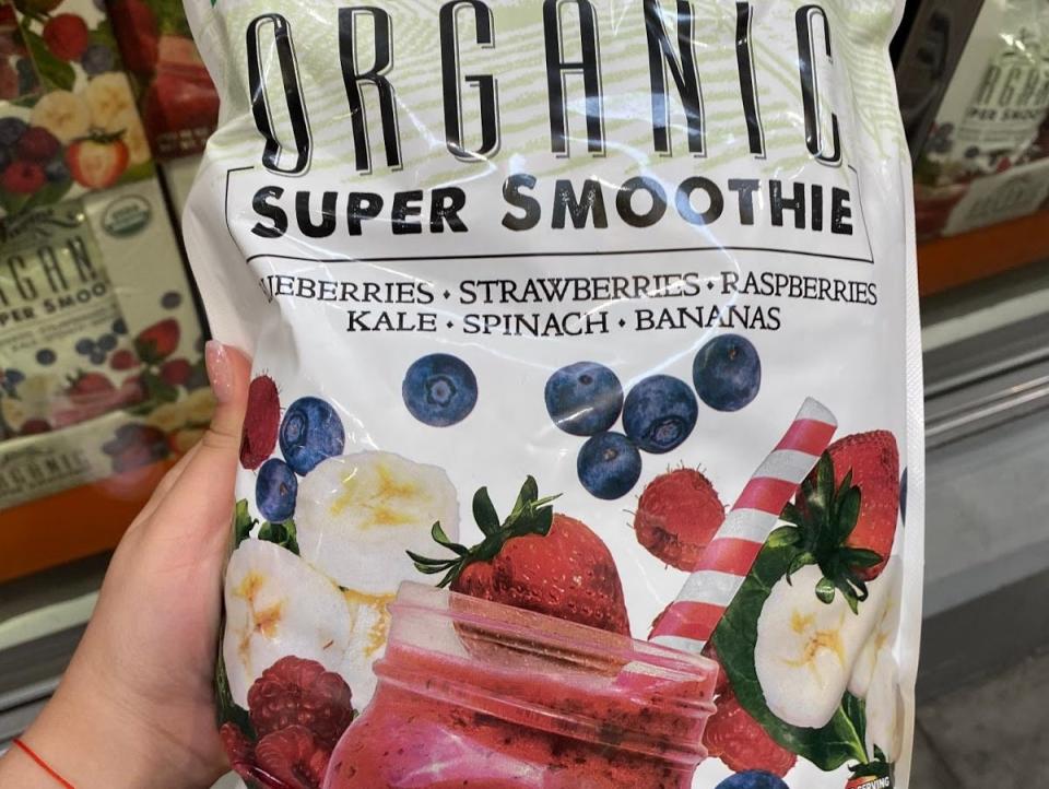 hand holding costco organic super smoothie frozen mix