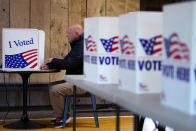 Jeff Gaeth votes Tuesday, April 2, 2024, at Yellow Rock Barn in Kansas City, Mo. Voters are being asked to decide whether to extend a sales tax to fund a new baseball stadium for the Kansas City Royals and football stadium improvements for the Kansas City Chiefs. (AP Photo/Charlie Riedel)