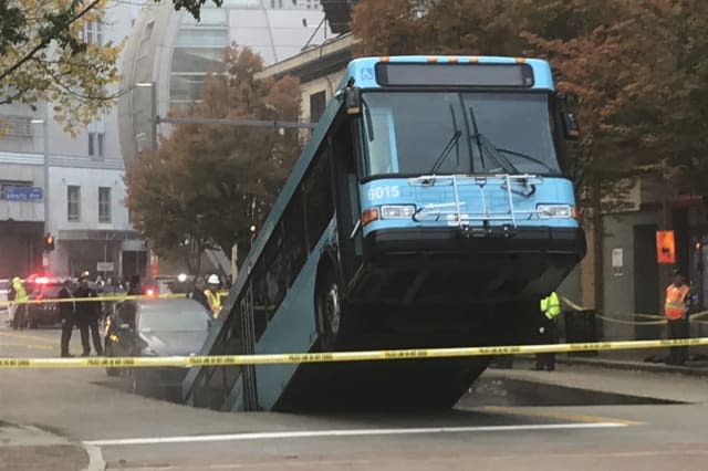 Sinkhole swallows part of city bus during rush hour